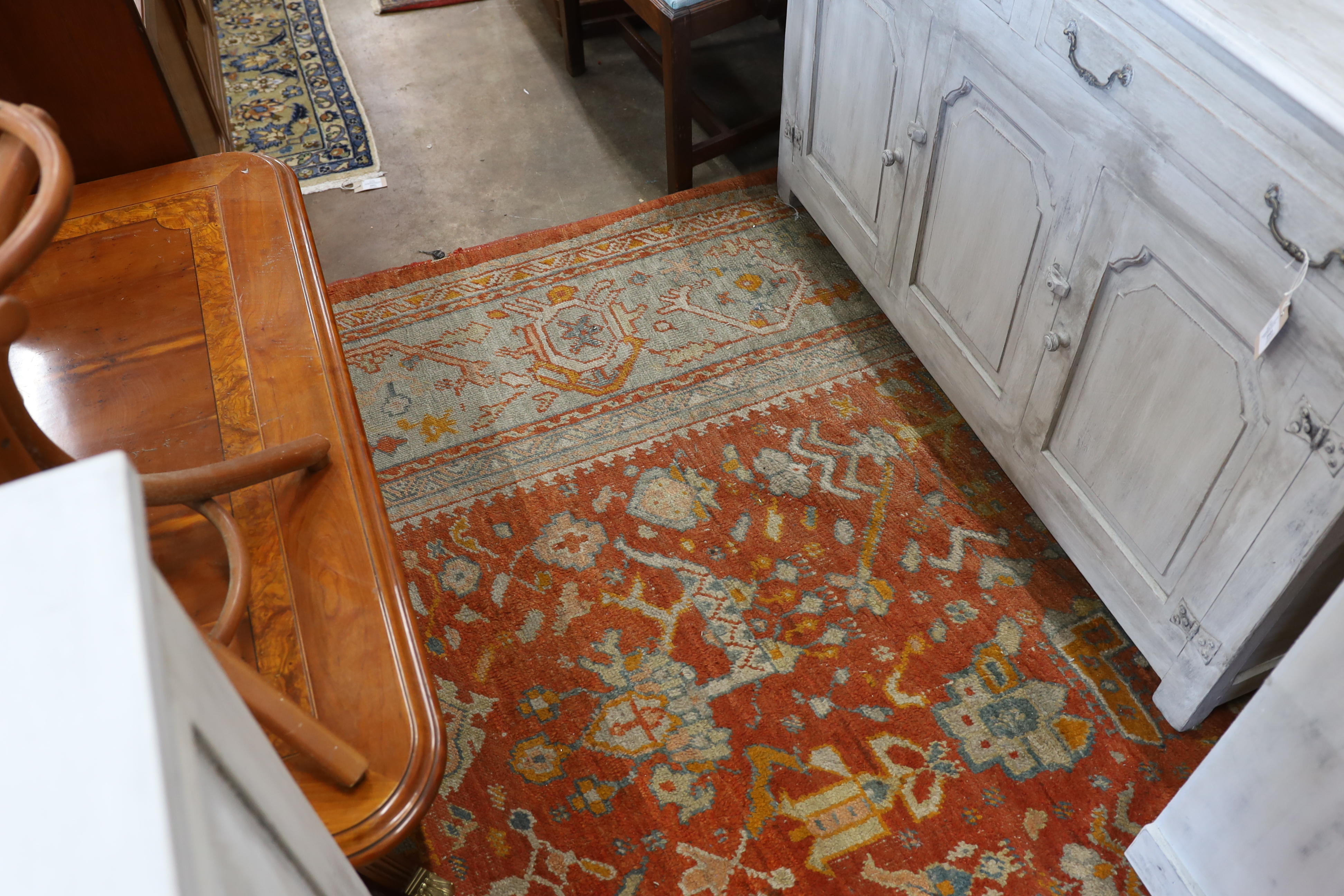 An Afghan red ground carpet, 395 x 310cm